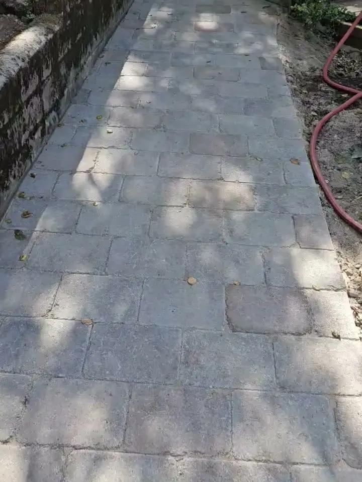 The same walkway rebuilt in new gray pavers