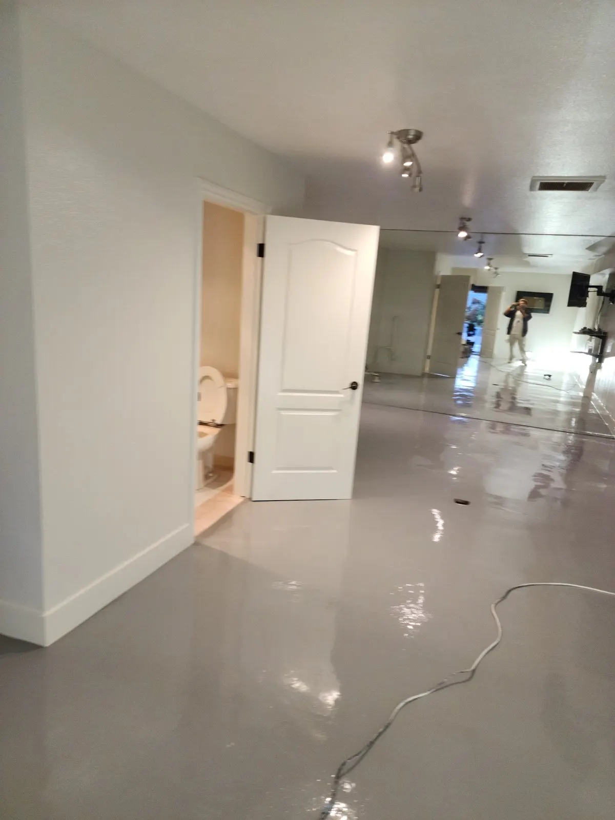 Finished hallway with white walls and new floor