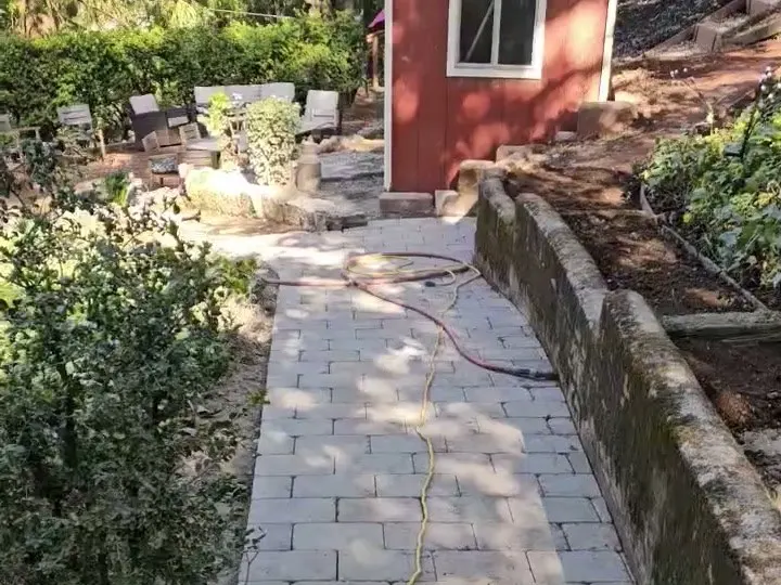 New paver walkway running up to a red shed